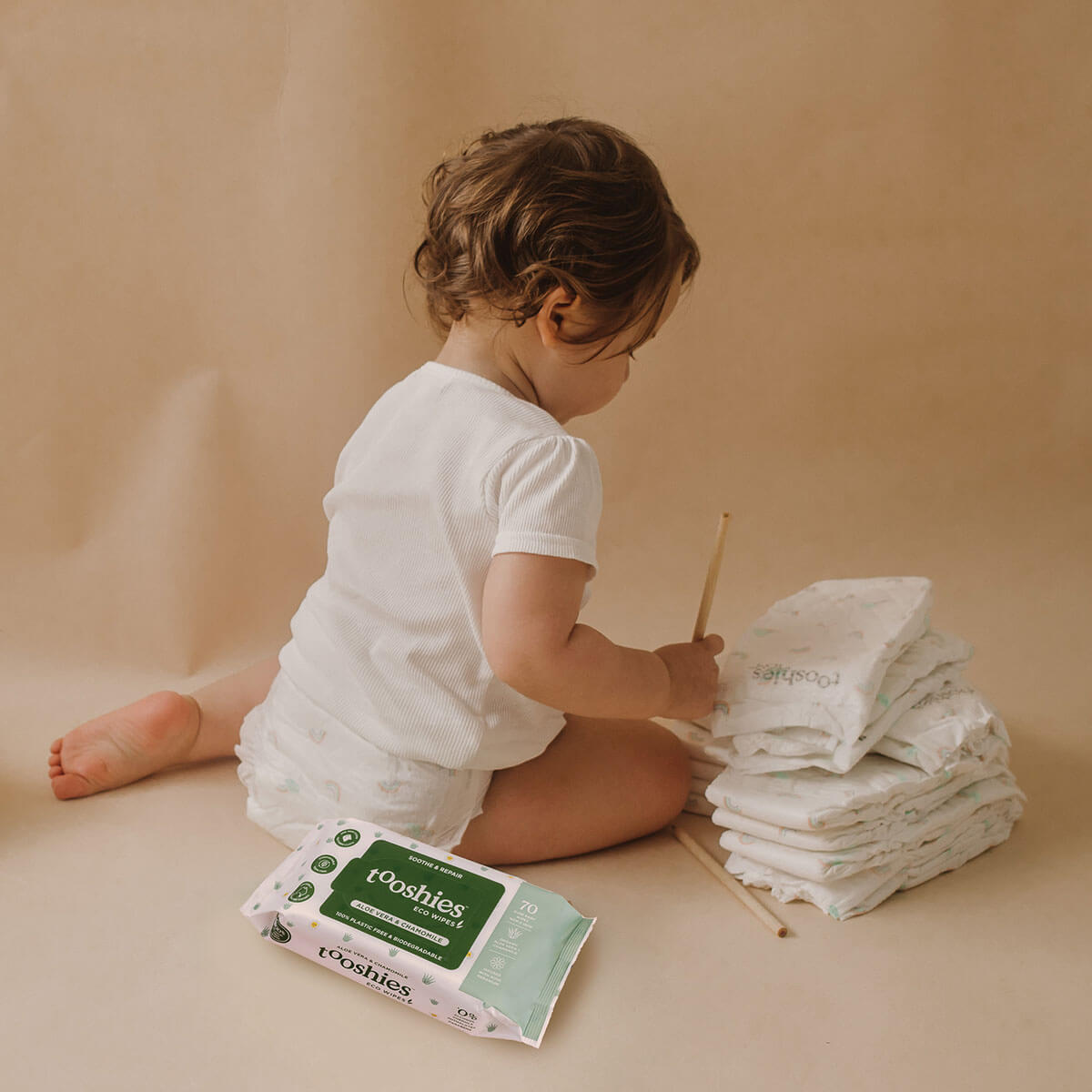 Baby next to eco-friendly Tooshies nappies at the Melbourne parenting and baby expo.