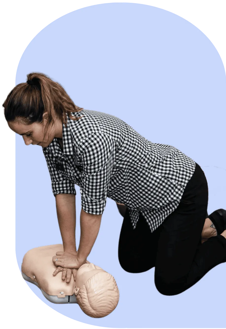 Hands-on baby first aid course session with a woman learning CPR techniques at the Sydney Baby Expo.