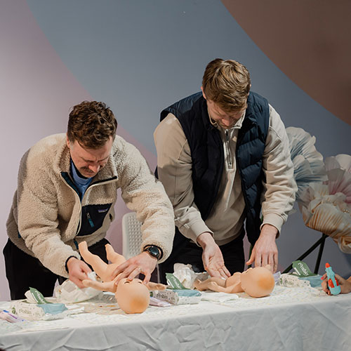 Two dads competing for nappy changing at the baby expo melbourne